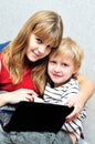 Sister teaching brother using notebook