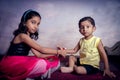 sister tying rakhi thread on brother wrist