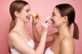 Sisterhood of beauty. Makeup-Free confidence. Side view portrait of young attractive girls applying make-up foundation