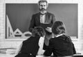 sisterhood. children girls and teacher man. Elementary School Teacher Giving Support In Classroom. Pupil Wearing Uniform