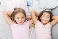Sisterhood concept. Sharing secrets. Kids relaxing on bed. Sisters preparing sleep. Nice evening. Best friends. Children