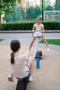 sisterhood, friendship. two charming teen girls having fun on a modern playground. sister, bffs communication