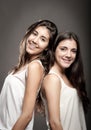 Sisters back to back Royalty Free Stock Photo