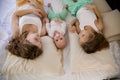 Three sisters on the bed in the bedroom in the morning Royalty Free Stock Photo