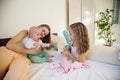 Three sisters on the bed in the bedroom in the morning Royalty Free Stock Photo