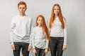 Sisters, brothers with natural red hair posing at camera