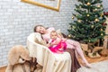 Sisters on Christmas eve at decorated living room Royalty Free Stock Photo