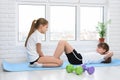 Sisters do sports exercises at home in self-isolation mode