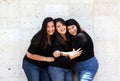 Happy black straight hair latin adult sisters dressed in black for family photo shoot in harmony and joy Royalty Free Stock Photo