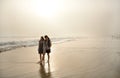 Sisters enjoying time together on beautiful foggy beach. Royalty Free Stock Photo