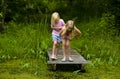 Sisters Exploring Pond Royalty Free Stock Photo