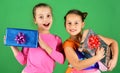 Sisters with gift boxes for holiday. Girls with cheerful faces