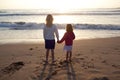 Sisters holding hands at the beach