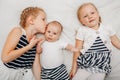 Sisters holding kissing little baby Royalty Free Stock Photo