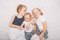 Sisters holding kissing little baby Royalty Free Stock Photo