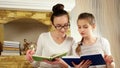 Sisters with interest spending time after book reading, girls spend free time together