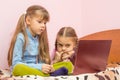 Sisters are interested in watching a laptop screen Royalty Free Stock Photo