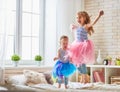 Sisters jumping on the bed Royalty Free Stock Photo