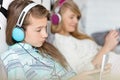 Sisters listening music through headphones at home Royalty Free Stock Photo