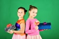 Sisters with lollipops, boxes and bags. Children eat colorful caramels