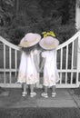 Sisters Looking over Garden Gate