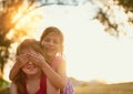 Sisters make the best friends. Portrait of two cute sisters playing together in the park. Royalty Free Stock Photo