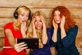 Sisters make fun selfie, listening to music on headphones Royalty Free Stock Photo