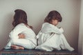 Sisters in nightgowns play on old trunk