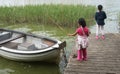 Sisters palying in the nature with a boat Royalty Free Stock Photo