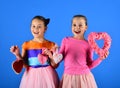Sisters with paper decorative furry hearts. Children celebrate Valentines day