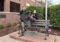 Sisters posing with bronze of Will Rogers on a bench, Claremore, Oklahoma Royalty Free Stock Photo