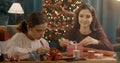 Sisters preparing Christmas gifts together