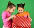 Sisters with red polka dotted gift box for holiday.