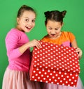 Sisters with red polka dotted gift box for holiday. Royalty Free Stock Photo