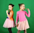 Sisters with round and long shaped lollipops. Treatment and sweets Royalty Free Stock Photo