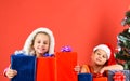 Sisters in Santa Claus hats with gift boxes and packages Royalty Free Stock Photo