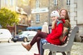 The sisters are sitting on the bench