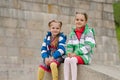 Sisters sitting on a granite ramp