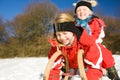 Sisters in snow on toboggan Royalty Free Stock Photo