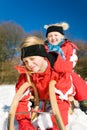 Sisters in snow on toboggan Royalty Free Stock Photo