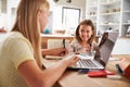 Sisters spending time together with computers at home