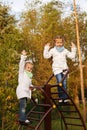 Sisters swarms up stairs on playground. Royalty Free Stock Photo