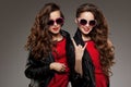 Sisters twins in hipster sun glasses laughing. Two fashion model Royalty Free Stock Photo