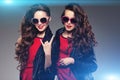 Sisters twins in hipster sun glasses laughing. Two fashion model Royalty Free Stock Photo