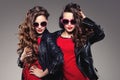 Sisters twins in hipster sun glasses laughing Two fashion models Royalty Free Stock Photo
