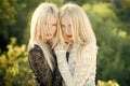 Sisters twins posing on natural landscape