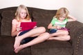 Sisters using tablets