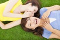 Sisters whispering on the meadow and happy expression Royalty Free Stock Photo
