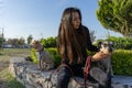 sit woman with two dogs in a park, pet a dog Royalty Free Stock Photo