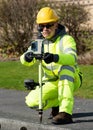 Site engineer doing road survey using modern robotic total station EDM before beginning of construction works and setting